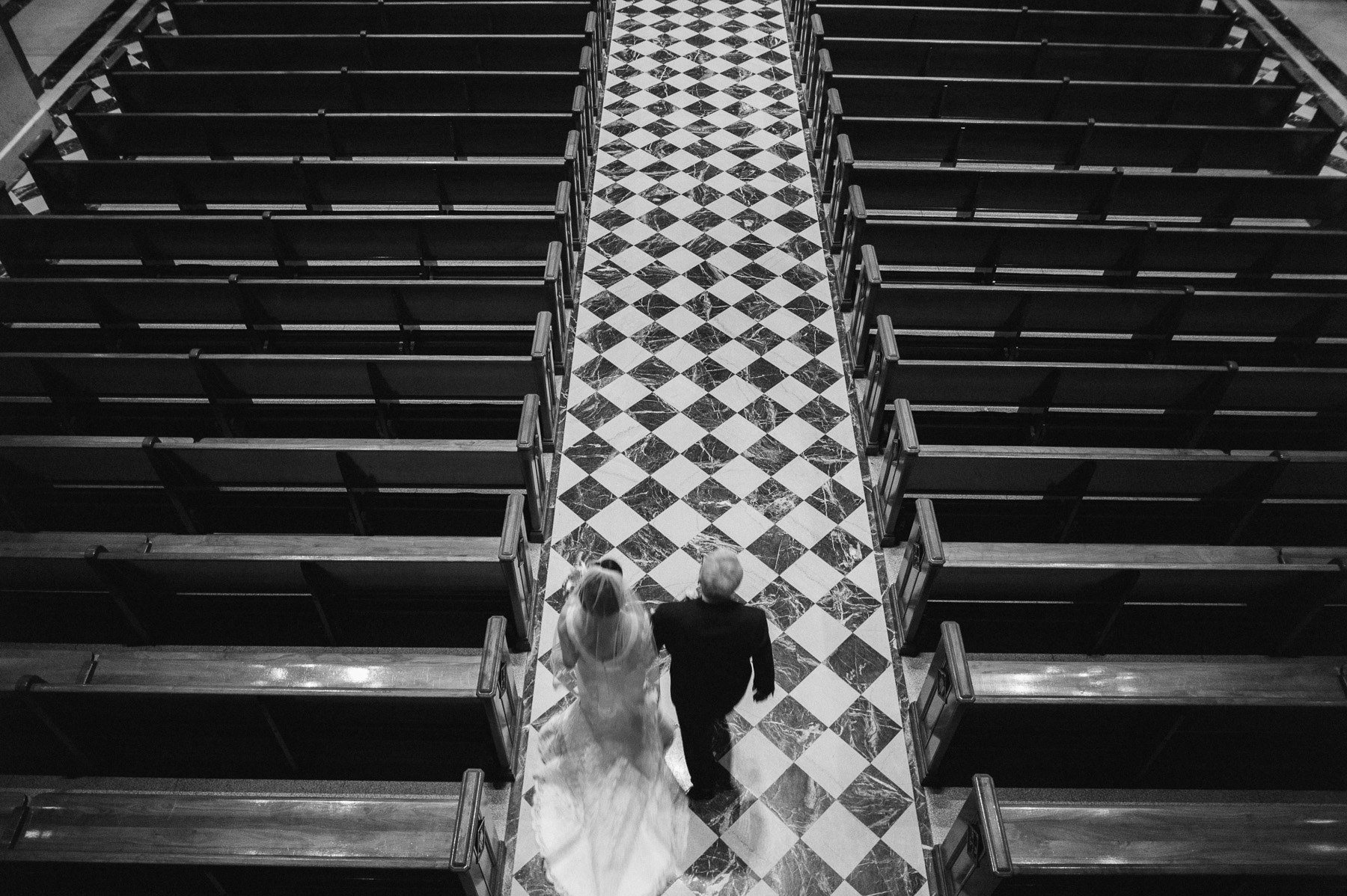 Father walk daughter down aisle at the Cathedral Basilica of Sts Peter and Paul